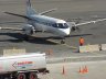 Business Express Airlines, BEX, on the ground at Logan Airport in Boston with it's propeller blades spinning