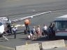 Passangers depart from a BEX plane at Boston Logan Airport