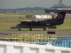 A turbo-prop prepares to take off from Boston Logan Airport as a ship passes by in Boston Harbor