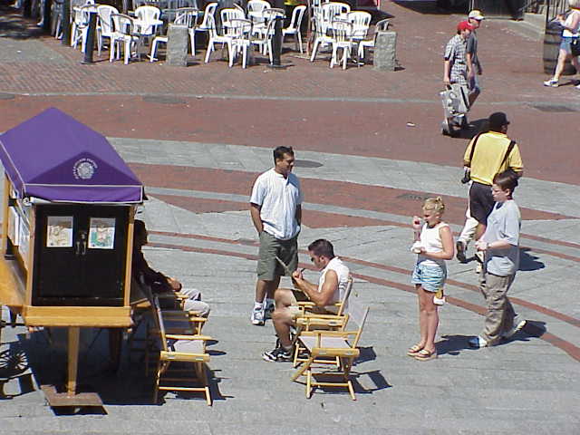 Watching over the shoulder of an artist in Boston's Quincy Market