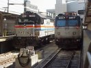  number 907 sits next to Amtrak diesel locomotive 525