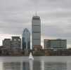 Towers and a sailboat on the Charles River