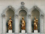 The statues over the fron door to the Crown building