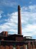A smokestake at the Saxonville Mills steaches into the Framingham blue sky